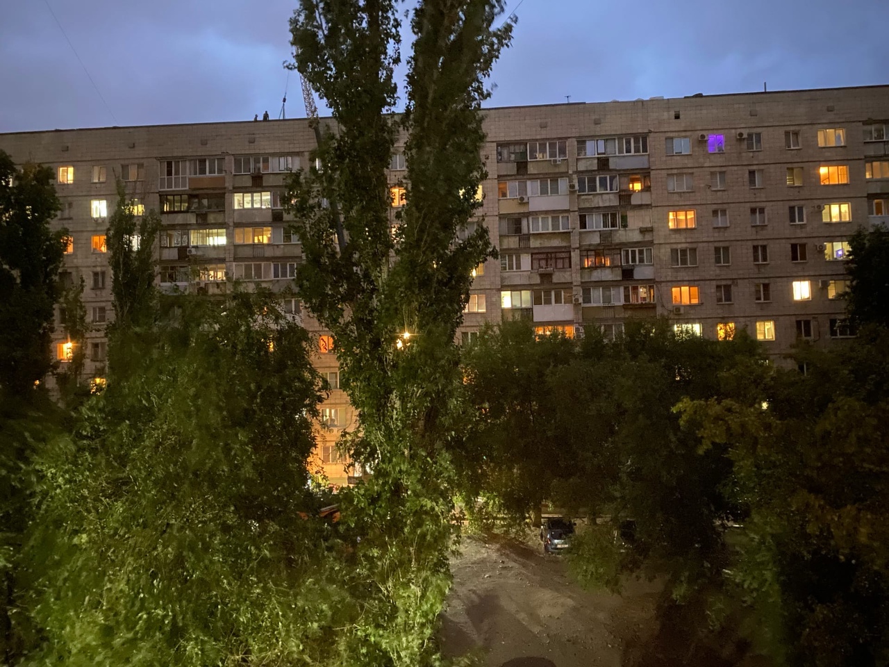 В темноте под проливным дождем чинят кровлю девятиэтажки на севере Волгограда